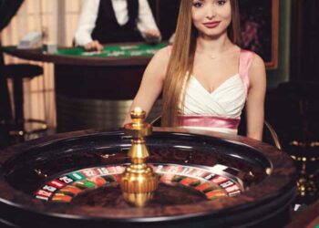 Girl sitting behind the roulette wheel