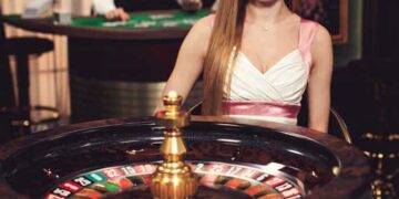 Girl sitting behind the roulette wheel