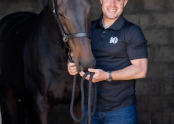 Adam Marcus with a 10bet shirt and hat next to his horse