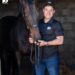 Adam Marcus with a 10bet shirt and hat next to his horse