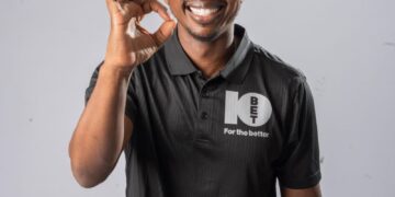 Andile doing the OK sign in a 10bet shirt
