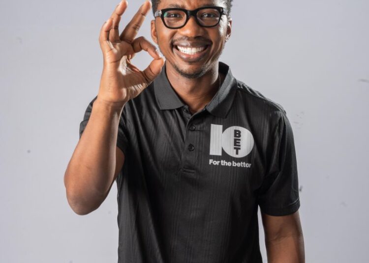 Andile doing the OK sign in a 10bet shirt